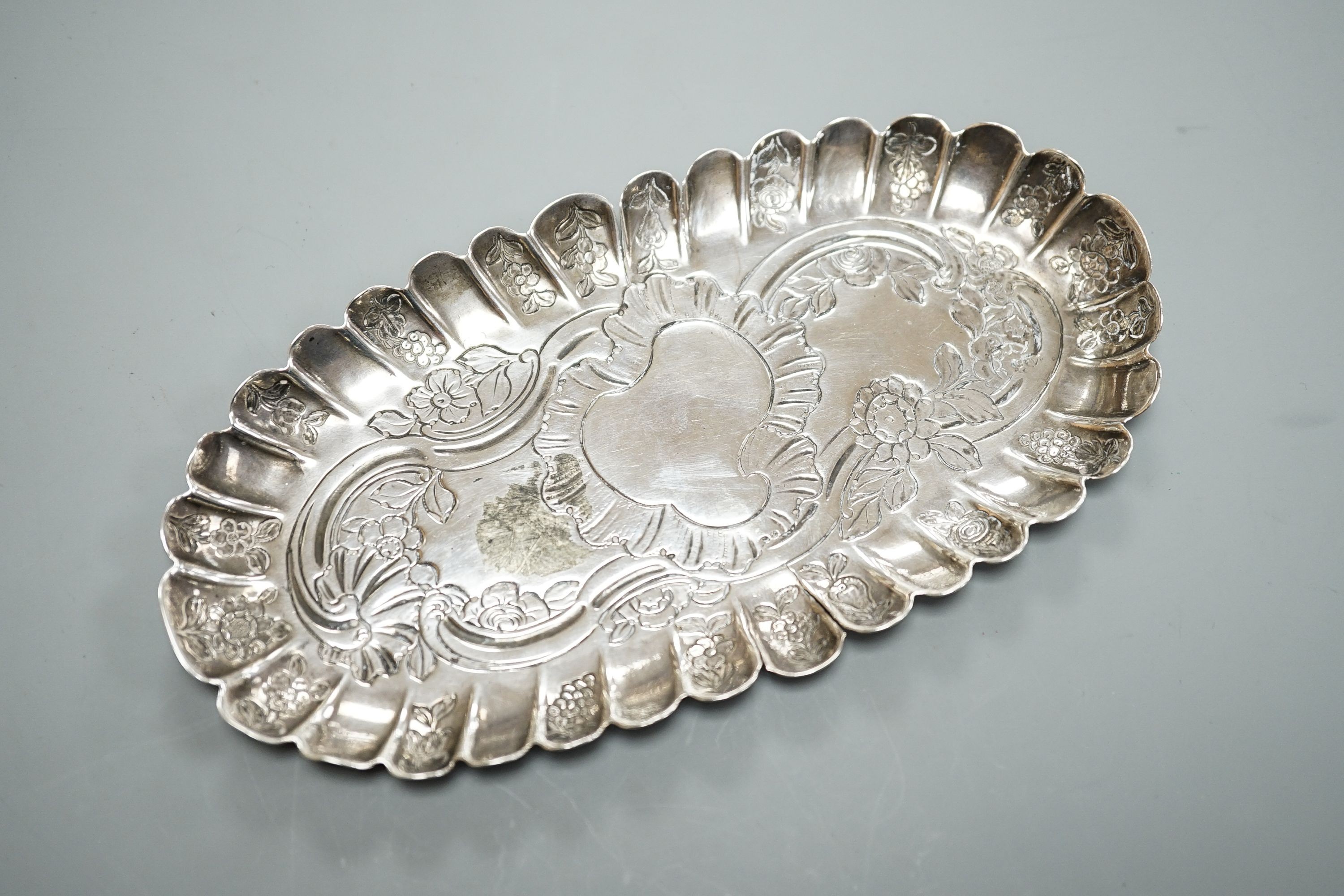 A mid 18th century Irish embossed silver oval pin tray, with engraved date and initials, maker ID?, Dublin, circa 1750, 16.4cm, 74 grams (a.f.)